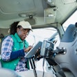 female truck driver on a tablet