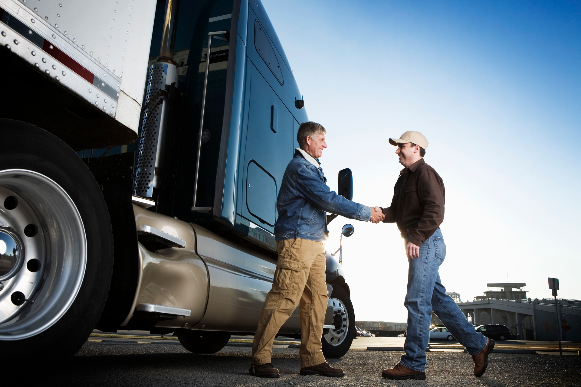 Customer shaking hands with truck sales rep.