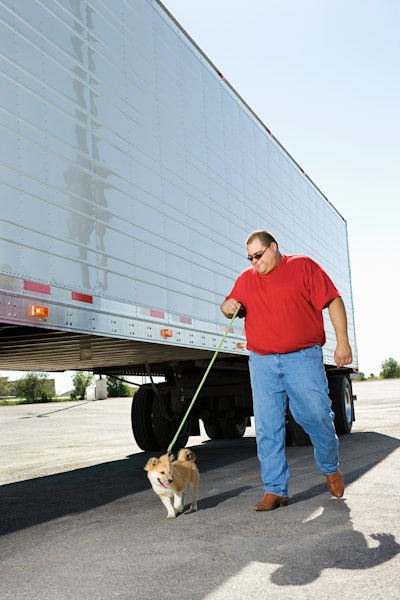 Truck driver walking his dog