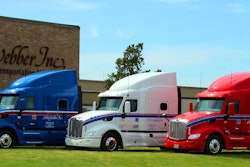 A.N. Webber headquarters with red, white, and blue semi-trucks parked in front of it