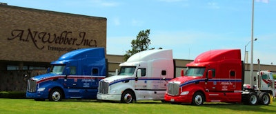 A.N. Webber headquarters with red, white, and blue semi-trucks parked in front of it