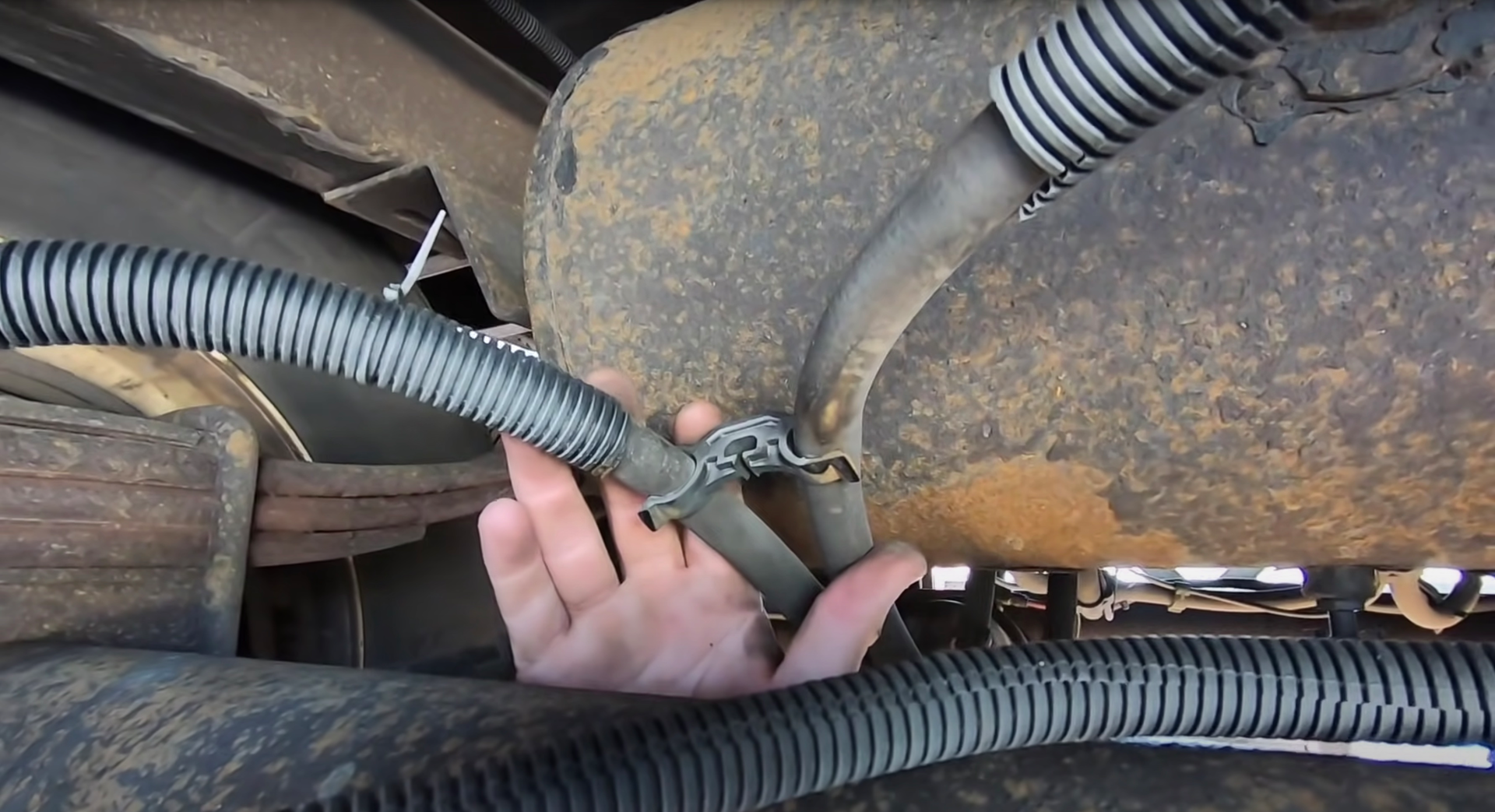 Florida Highway Patrol inspector points out a chafed brake air line hose