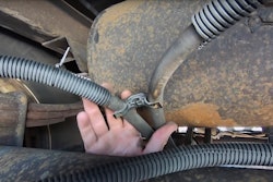 Florida Highway Patrol inspector points out a chafed brake air line hose