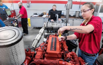 UTI female student working on a cummins engine