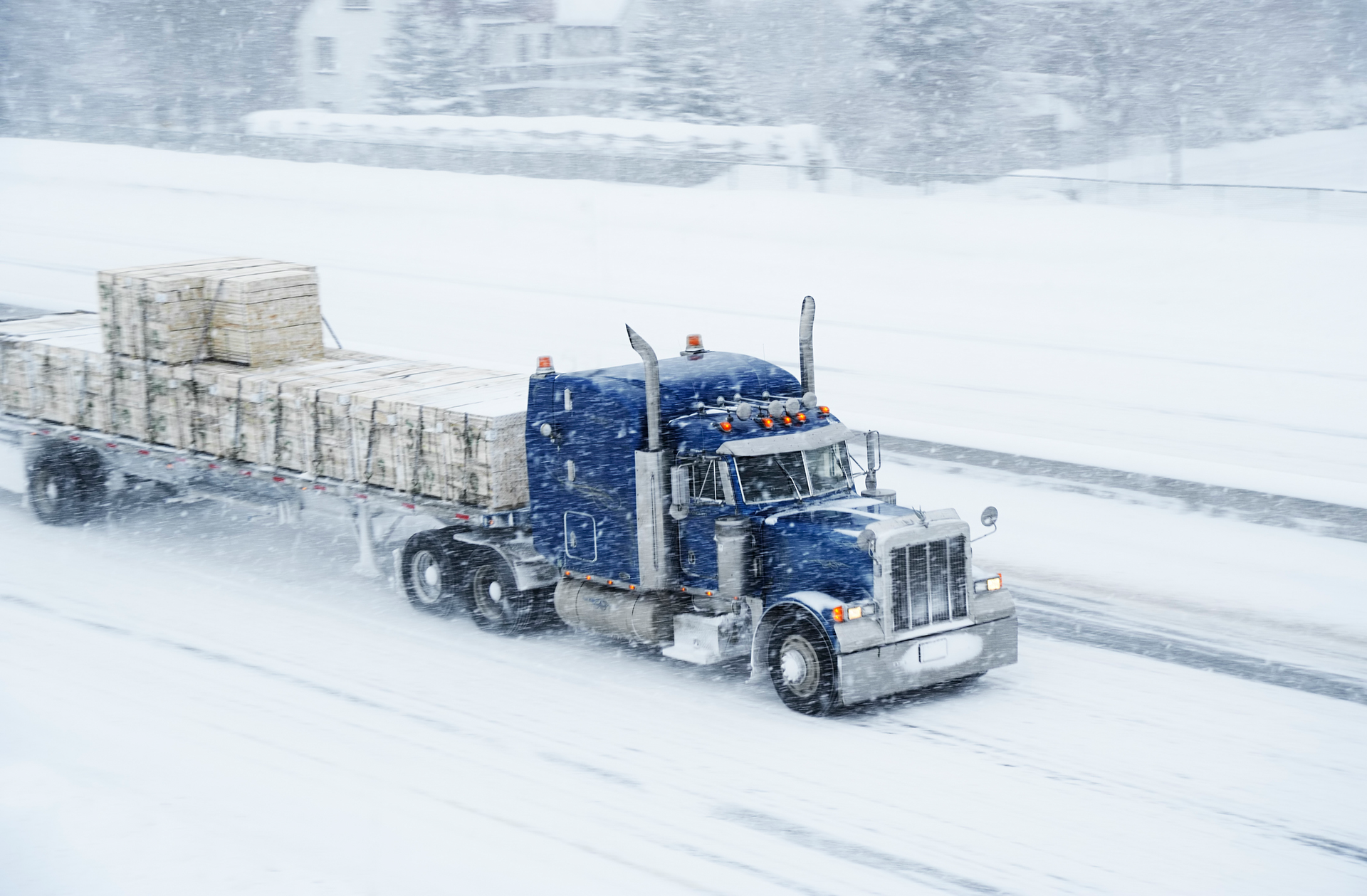 semi truck driving in the snow