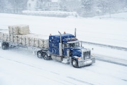 semi truck driving in the snow