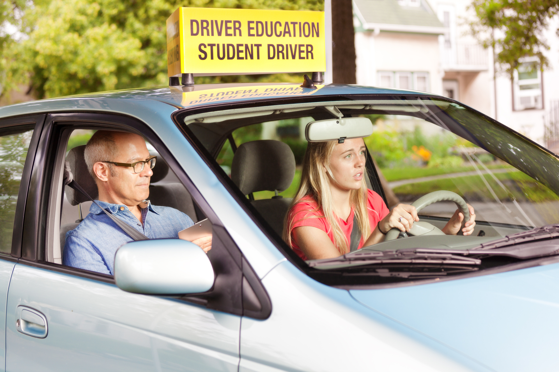 student driver in car with teacher