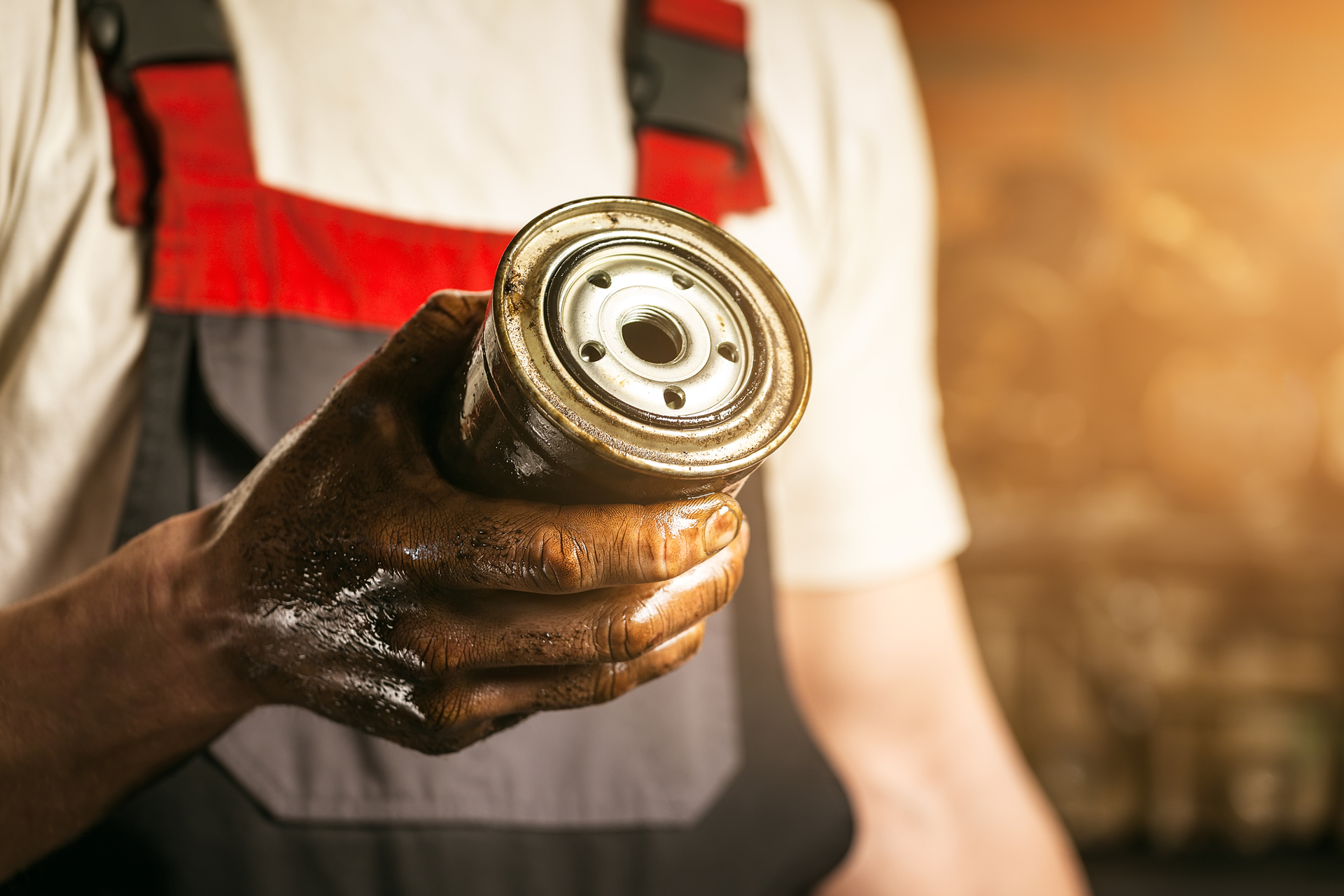 mechanic holding an oil filter