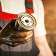 mechanic holding an oil filter