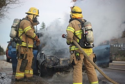 firefighters extinguishing a car fire