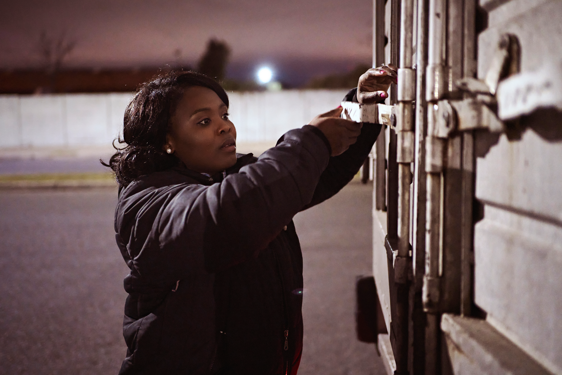 female truck driver securing cargo