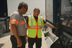 technicians inspecting a truck