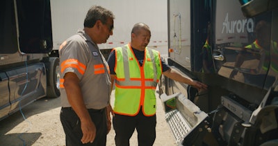 technicians inspecting a truck