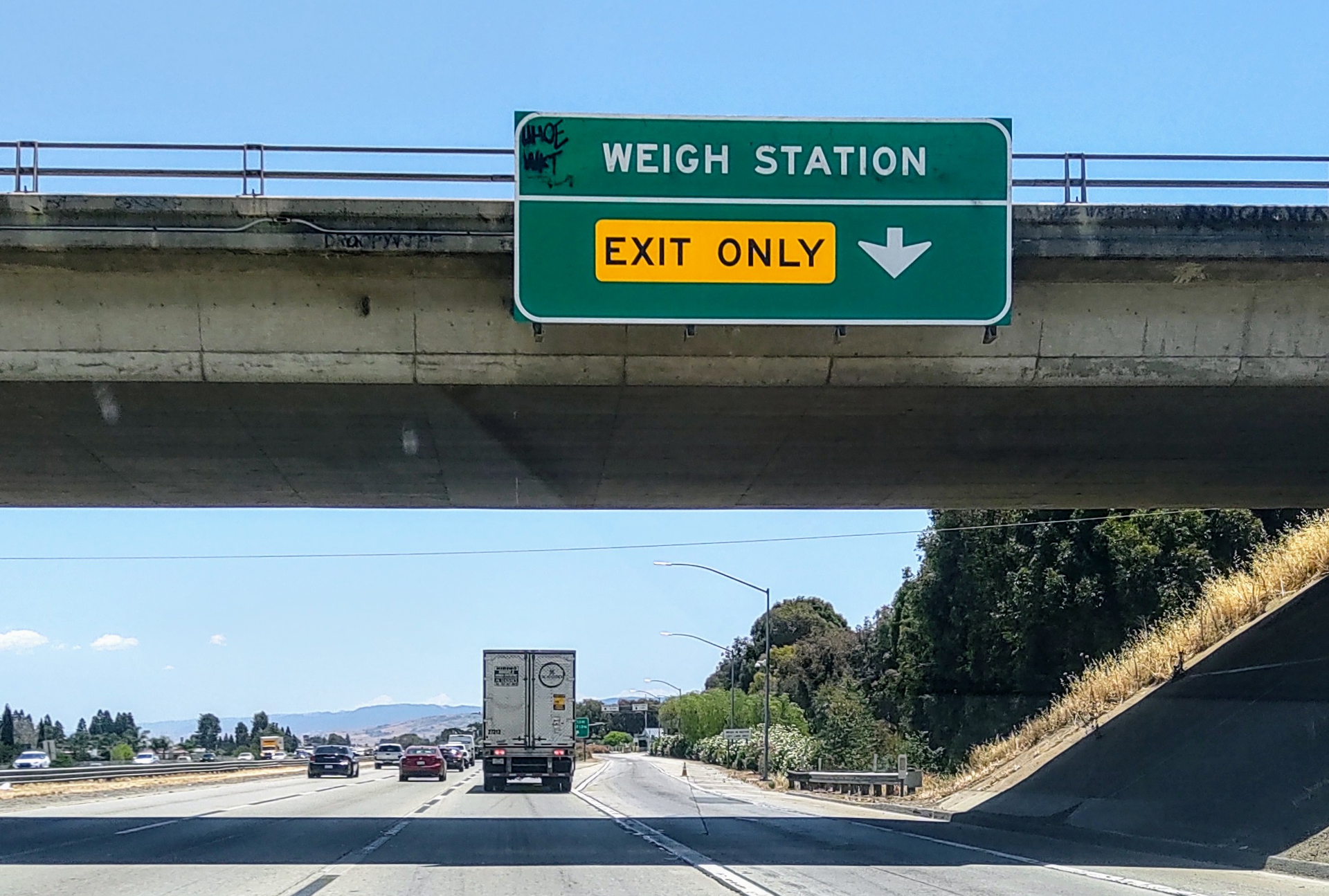 California highway with weigh station exit only sign