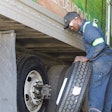 man changing a trailer tire