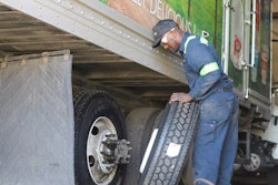 man changing a trailer tire