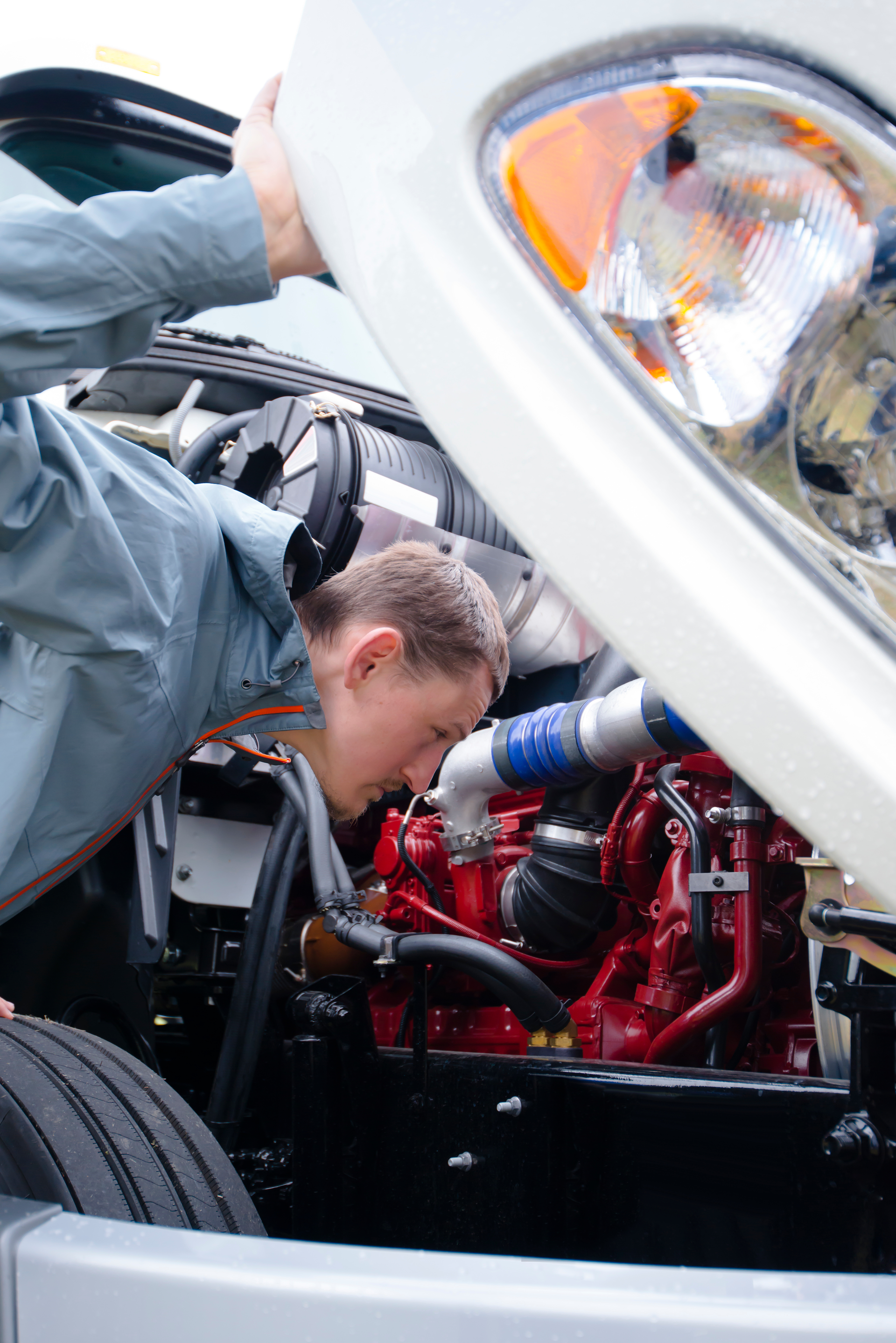 driver inspecting a diesel engine