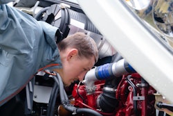 driver inspecting a diesel engine