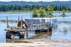 log trailer in a flood