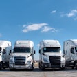 Four Byland Transportation semi-trucks parked in a row