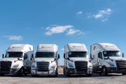 Four Byland Transportation semi-trucks parked in a row