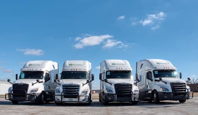 Four Byland Transportation semi-trucks parked in a row