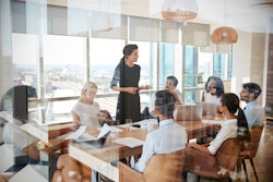 a woman speaking to a group of people