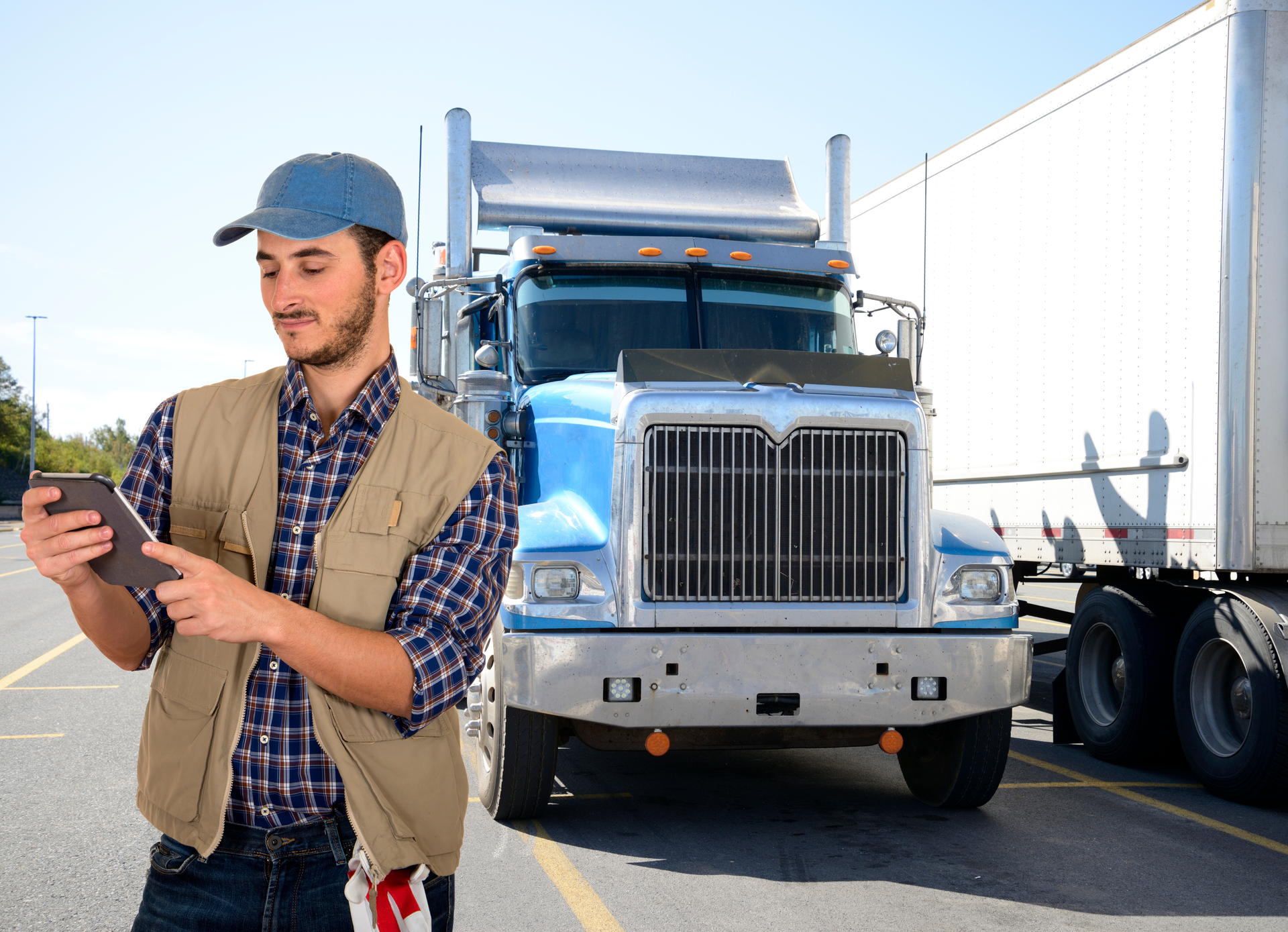 Truck driver looking at a tablet