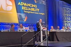 A group of men on a stage talking about brake linings.