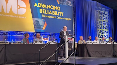 A group of men on a stage talking about brake linings.