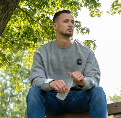 Man wearing Cummins logo sweatshirt