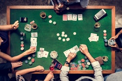 five people playing poker