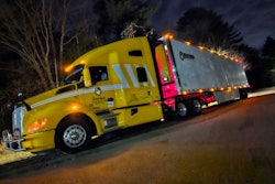 Brakebush Kenworth semi-truck at night with lights on