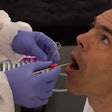 nurse collecting an oral fluid sample