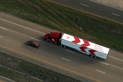 Kodiak truck next to a car.