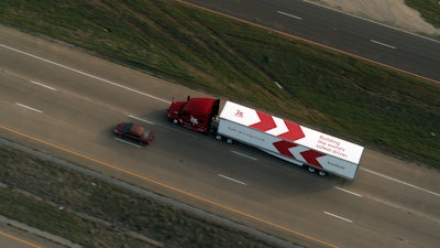 Kodiak truck next to a car.