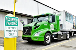 Electric truck parked next to a charging station