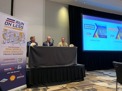 NACFE executive director Mike Roeth, right, talks with Jake VandeLoo vice president of equipment engineering at Schneider (center) and Drew Cullen, vice president of fuels and environmental affairs for Penske Truck Leasing.