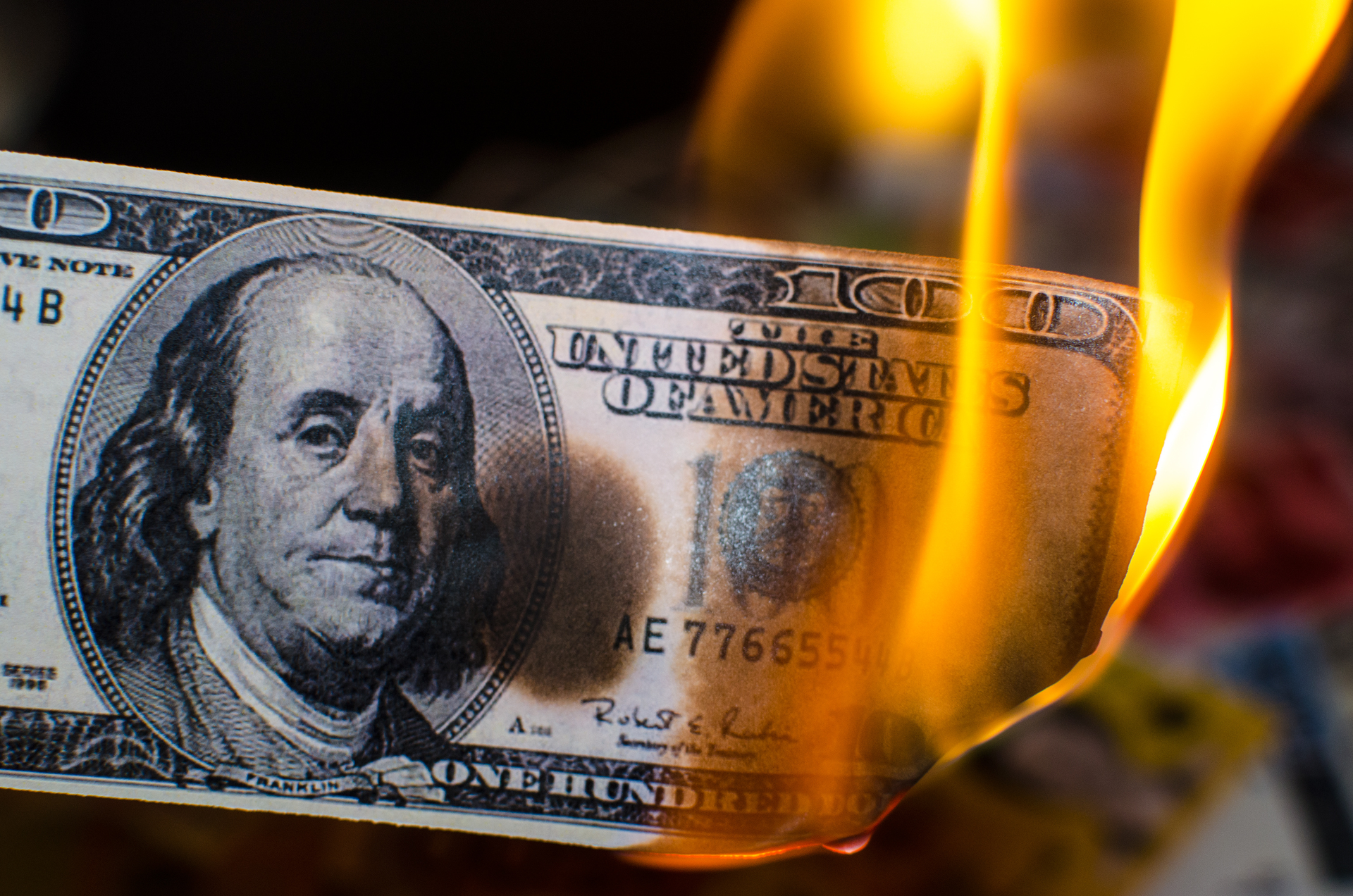 A $100 bill on fire