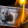 A $100 bill on fire