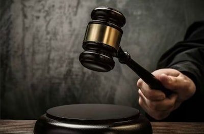 A person hitting a stand with a gavel