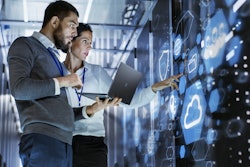 man and a woman looking at a server