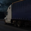semi truck on highway with moon