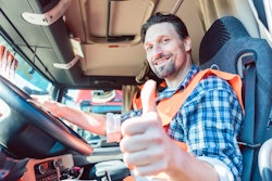happy truck driver in cab