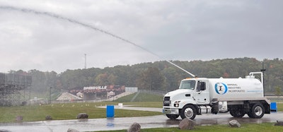 Mack MD 7 water truck spraying water