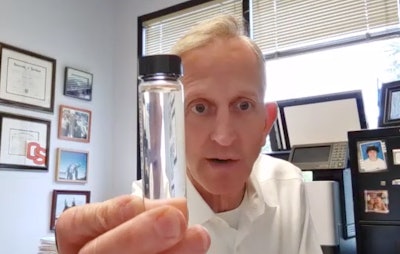 Keith Wilson, president of Portland, Oregon-based LTL carrier Titan Freight, shows a vial of renewable diesel, which is clear versus the yellowish-amber color of petroleum diesel.