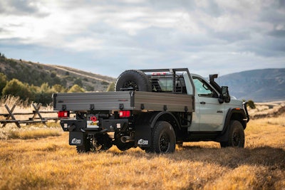 AEV GMC Sierra Grande Concept parked in field rear view mountain background