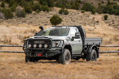 AEV GMC Sierra Grande Concept parked in field hilly background