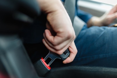 man buckling a seatbelt