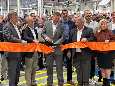 people cutting a ribbon